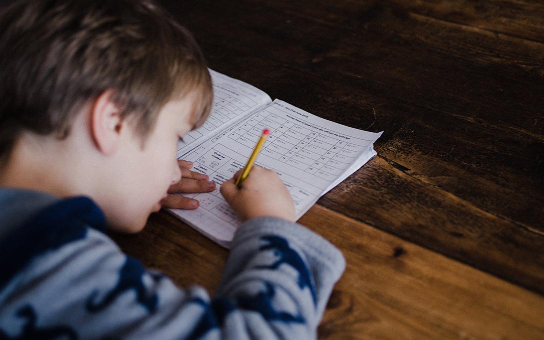 Young child completing a written assignment