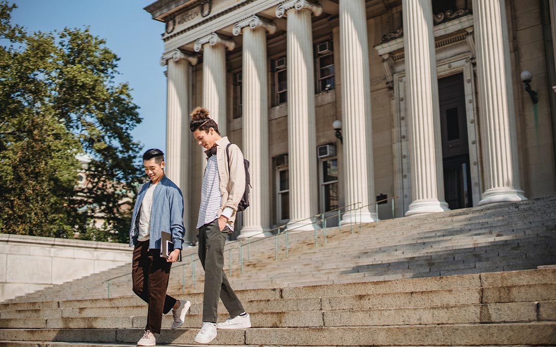 Two students walking on a college campus