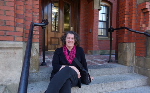 Susan Dynarski sitting on the steps of a building